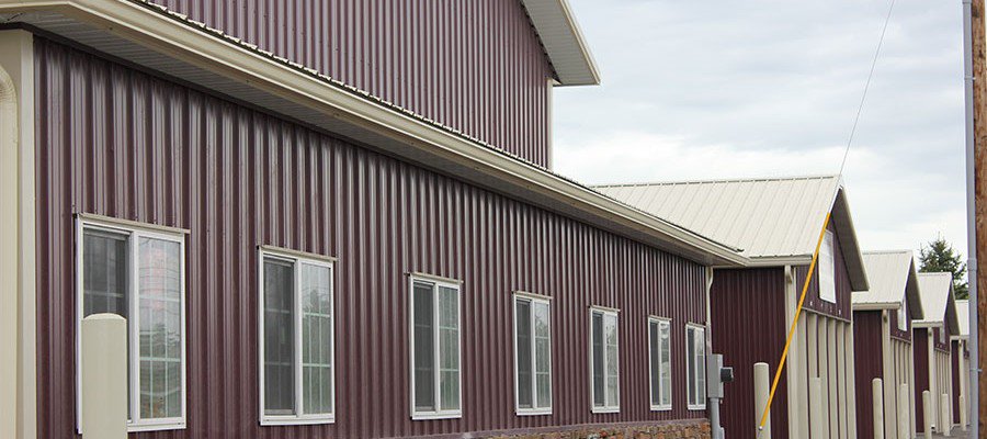 Maroon steel storage building with windows