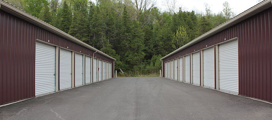 Facing rows of drive-up units with white roll-up doors